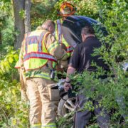 Personnel with the Greenville Department of Public Safety check to ensure there is no risk of fire after responding to a three-vehicle crash in Eureka Township Thursday afternoon. — DN Photo | Cory Smith